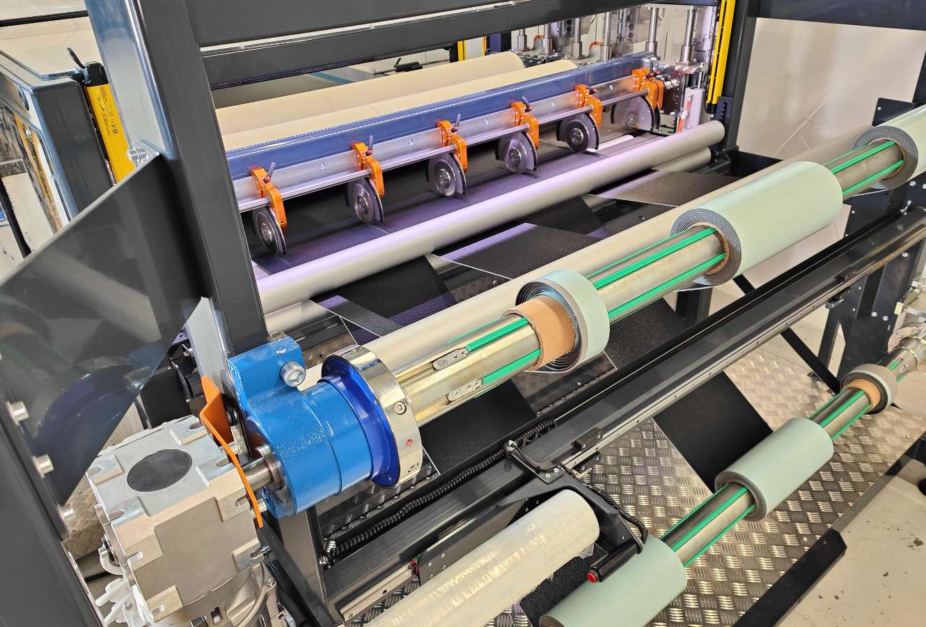 Slitting and rewinding at output of a bonding machine